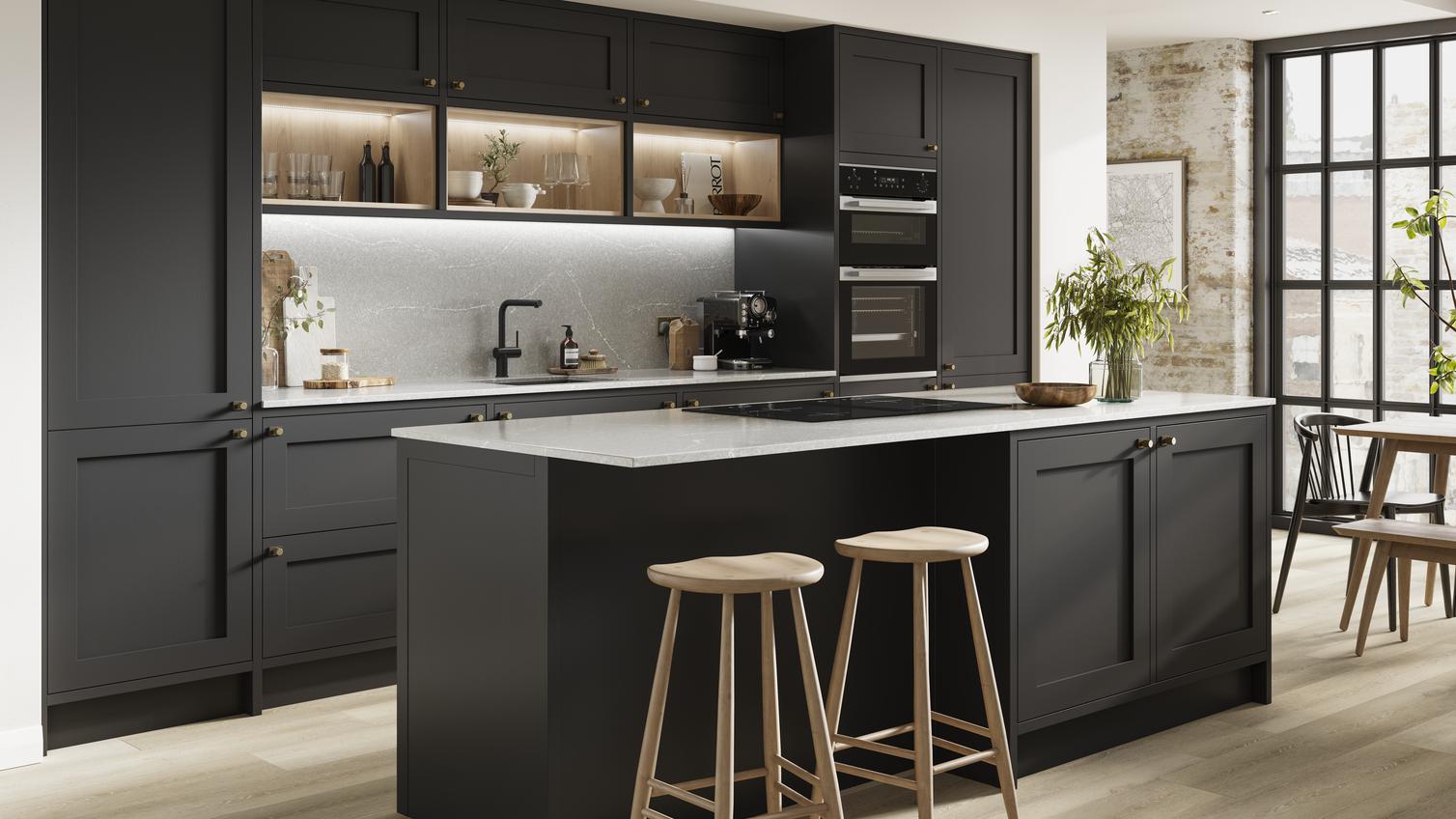Black matt kitchen with an island layout and in-frame cabinets. Includes white worktops and black tap for a two-tone design.